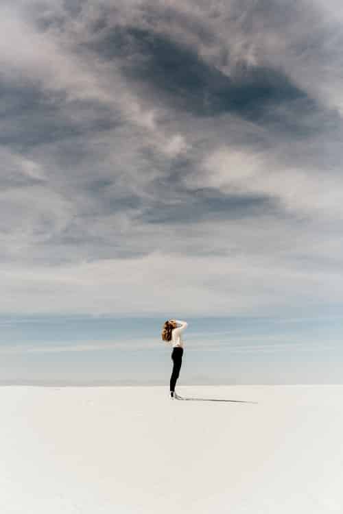 Woman standing on a sandy beach