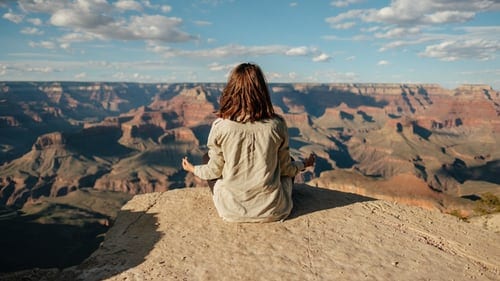 A person meditating on a mountain top