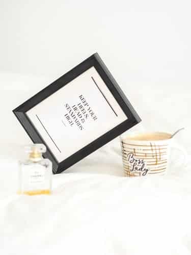 A bowl, perfume and a framed motivation quote that reads, "keep your heels, head and standards high" 