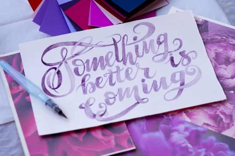 "Something better is coming" written in paint on a piece of paper