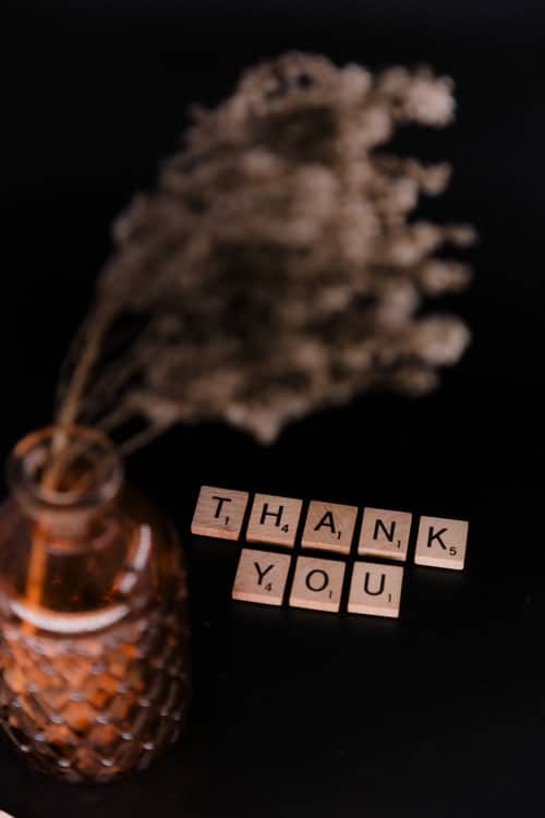 Scrabble pieces spelling out "thank you"