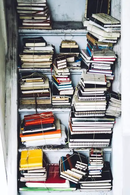 a cupboard full of used journals