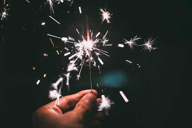 A hand holding a sparkler