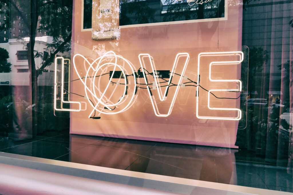 A neon sign that says, love