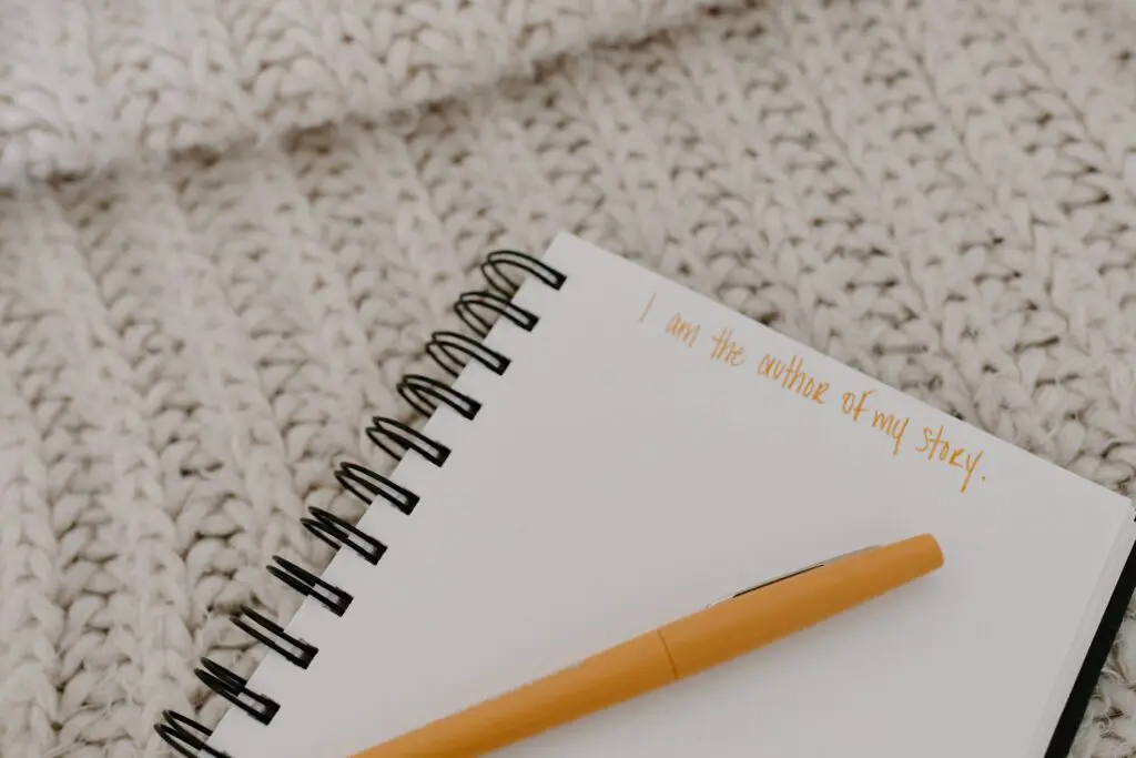 An open empty notebook on a knitted blanket.