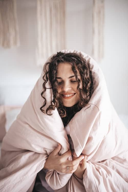 a woman wrapped in a duvet