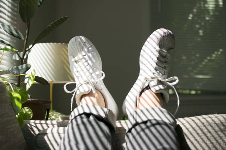 Two feet resting on a sofa at a therapy office